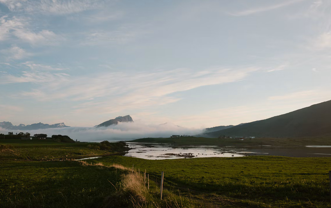 Green summer mountains and a coastal inlet in the Lofoten Islands, Norway
