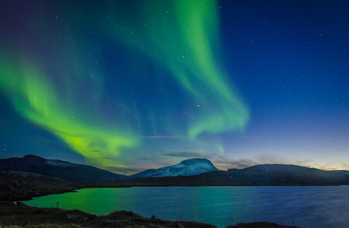 Northern Lights over a body of water in Abisko National Park, Sweden